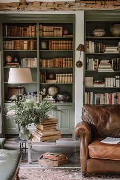 a living room filled with lots of books and furniture