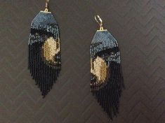 two pairs of beaded earrings with an image of a woman's face on them