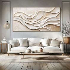 a living room with a white couch and large art piece on the wall above it