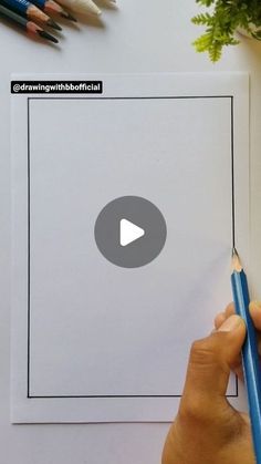 someone is holding a pencil in front of a sheet of paper