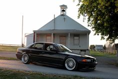 a black car parked in front of a house