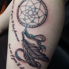 a woman's leg with a dream catcher tattoo on it and words written below