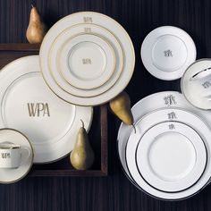 white and gold dinnerware with the word wpa written on it, including pears