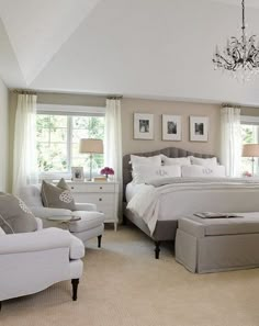 a bedroom with white bedding and furniture in it