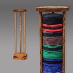 a wooden stand with several different colored ribbons on it and a small round table next to it