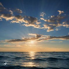 the sun is setting over the ocean with some clouds in the sky and water around it