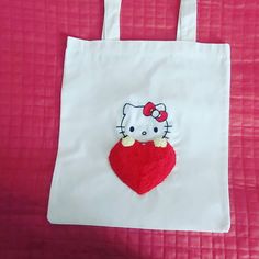 a hello kitty bag with a red heart on it