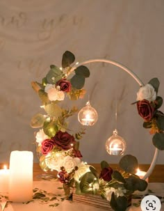 a table topped with candles and flowers on top of it