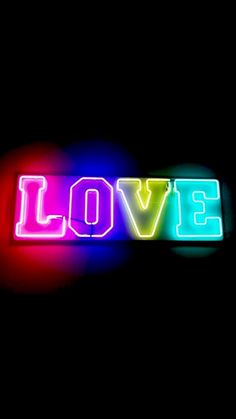 the word love spelled with neon lights on a black background