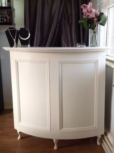 a white cabinet with flowers on top of it