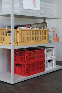 some crates are stacked on top of each other in front of a white book shelf