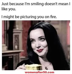 a woman with long black hair holding a cup in her hand and the caption just because i'm smiling doesn't mean like you