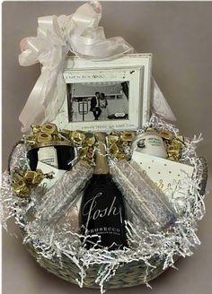 a gift basket filled with wine, champagne and other personalized items for someone's special occasion