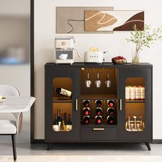 a cabinet with wine bottles and glasses on it next to a dining room table in front of a painting