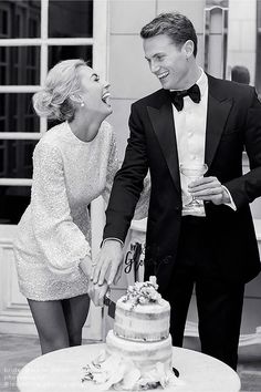 a man and woman cutting a cake together