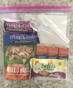 an assortment of nuts and milk in a plastic bag on the floor next to a package of fruit and grain