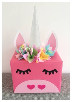 a pink box with a unicorn's face painted on it