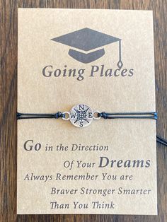 a bracelet that says go in the direction of your dreams with a graduation cap on it