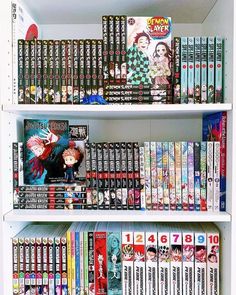 a book shelf filled with lots of books on top of white shelving unit shelves