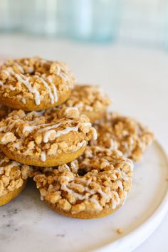 a white plate topped with donuts covered in frosting