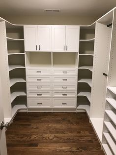 an empty walk in closet with lots of drawers and white cupboards on the walls