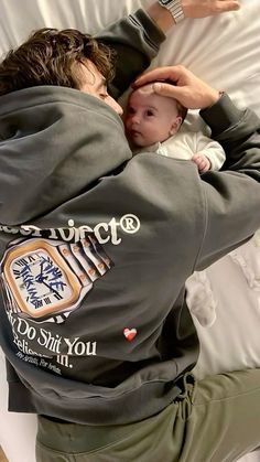 a man holding a baby in his arms