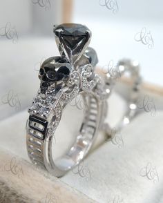 two wedding rings with skulls and diamonds on them