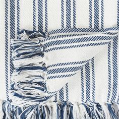 a blue and white striped blanket with fringes