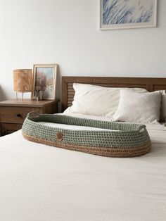 a bed that has a basket on top of it