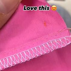 someone is stitching the edge of a pink piece of fabric