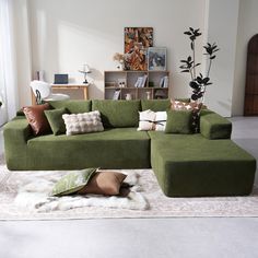 a green couch sitting on top of a white rug