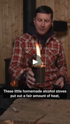 a man holding a lit candle in front of a wood burning stove with the caption, these little homemade alcohol stoves put out a fair amount of heat