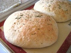 two loaves of bread sitting on top of a pan