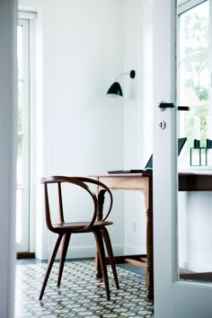 a wooden chair sitting in front of a desk