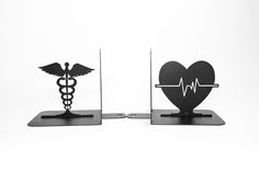 two black metal medical bookends with a stethoscope in the shape of a heart