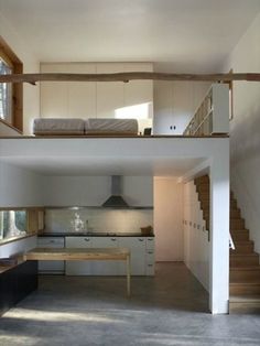 an open floor plan with stairs leading to the upper level