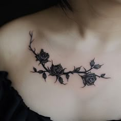 a woman's chest with black roses on it