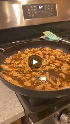 a skillet filled with food sitting on top of a stove next to an oven