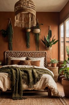 a large bed sitting in a bedroom next to potted plants