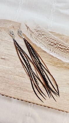 Wyld Sparrow Jewelry 
#featherearrings #longfeatherearrings, #realfeatherearrings #bohofeatherearrings, #hippieearrings #gypsyearrings #rodeoearrings #concertearrings #westernearrings #southwesternearrings #whitefeatherearrings #colorfulearrings #partyearrings #anniversarygifts #giftsforher #bohogifts #westerngifts #bohojewelry #westernjewelry #handmadegiftsforher #encouragementgifts #festivaljewelry #bohemianearrings #dramaticearrings #gypsystyle #bohoearrings #westernearrings #statementearrings #handmadejewelry Sparrow Jewelry, Country Earrings, Black Rodeo, Western Style Wedding, Western Dance, Dramatic Earrings, Earring Long, Western Gifts, Western Earrings