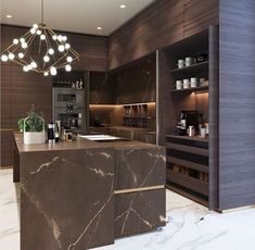 a modern kitchen with marble counter tops and dark wood cabinets, along with hanging lights