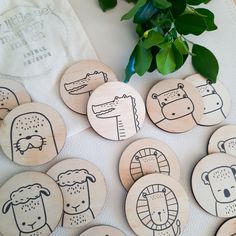 several wooden badges with animals drawn on them