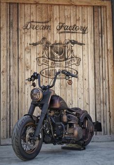 a motorcycle parked in front of a wooden wall