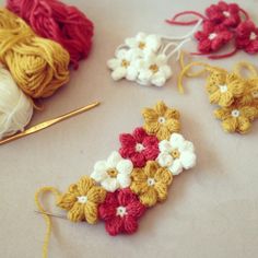 crochet flowers are being worked on with yarn