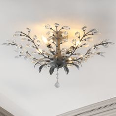 a chandelier hanging from the ceiling in a room with white walls and ceilings