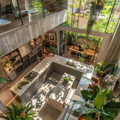 an aerial view of a living room and dining area in a house with glass walls