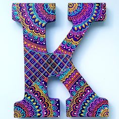 the letter k is decorated with colorful designs