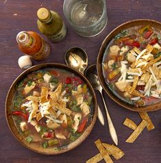 two bowls of soup with tortilla chips on the side