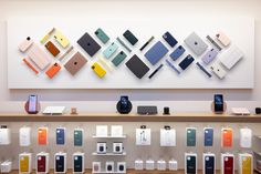 an apple store display with many different colored phones on the wall and in front of it