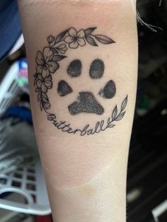 a dog's paw with flowers and leaves around it on the arm that says beautiful